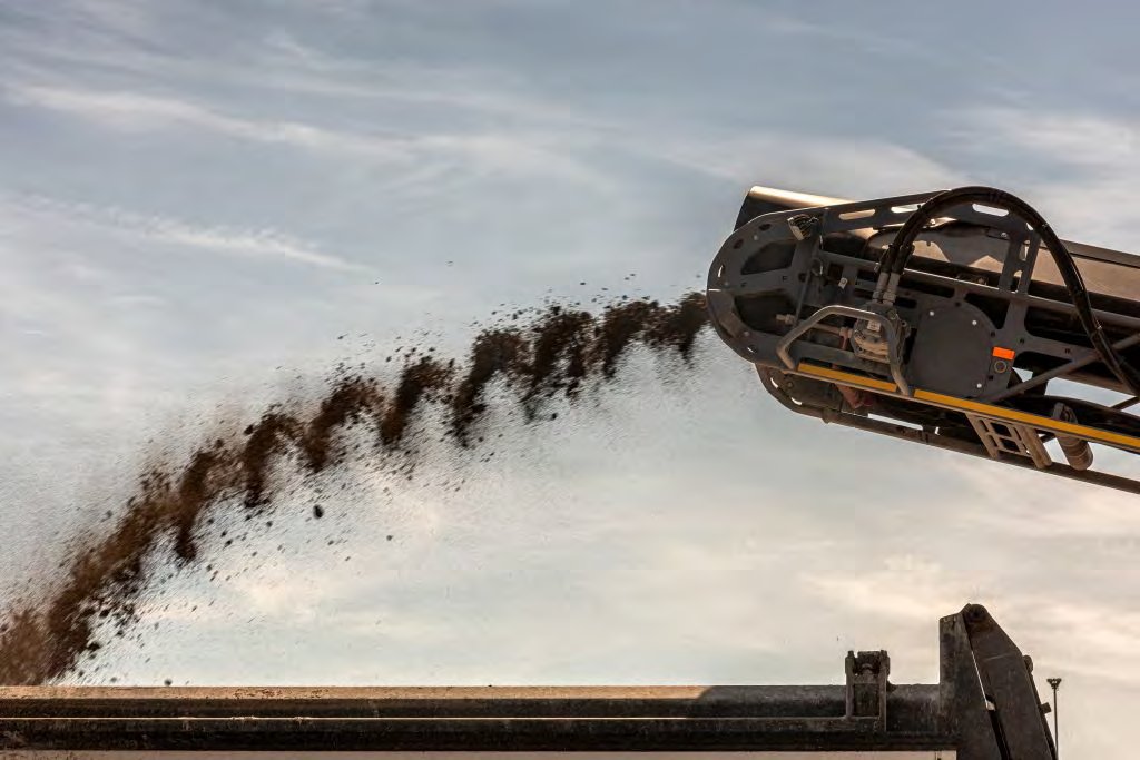 Road milling conveyor discharging asphalt grindings